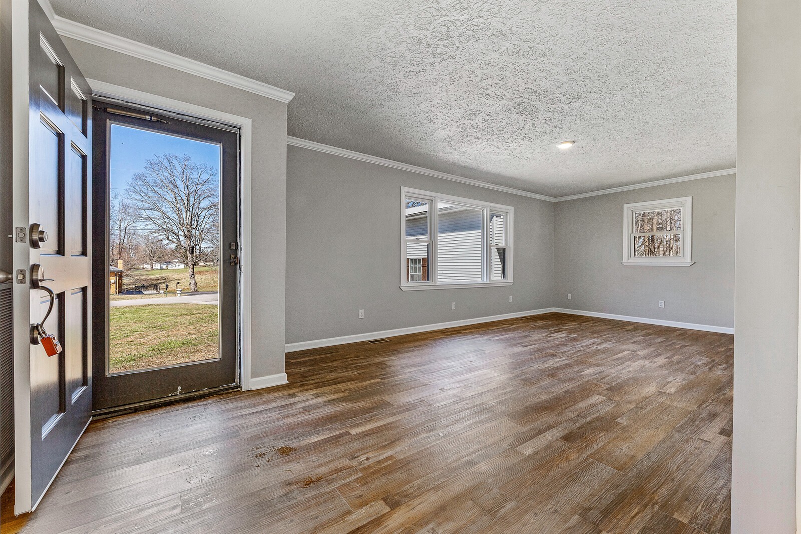 118 Rollins Road Sparta, TN 38583 - Photo 10 of 33 an empty room with wooden floor and windows