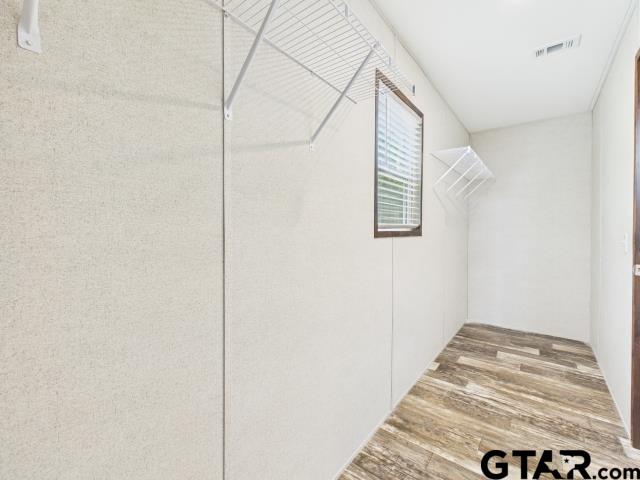 7191 Stella Street Murchison, TX 75778 - Photo 16 of 32 a view of small space with wooden floor and cabinet