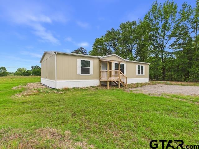 7191 Stella Street Murchison, TX 75778 - Photo 2 of 32 a front view of a house with garden