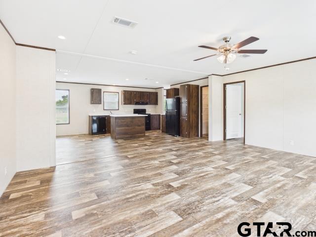 7191 Stella Street Murchison, TX 75778 - Photo 6 of 32 a view of livingroom with hardwood floor and a ceiling fan