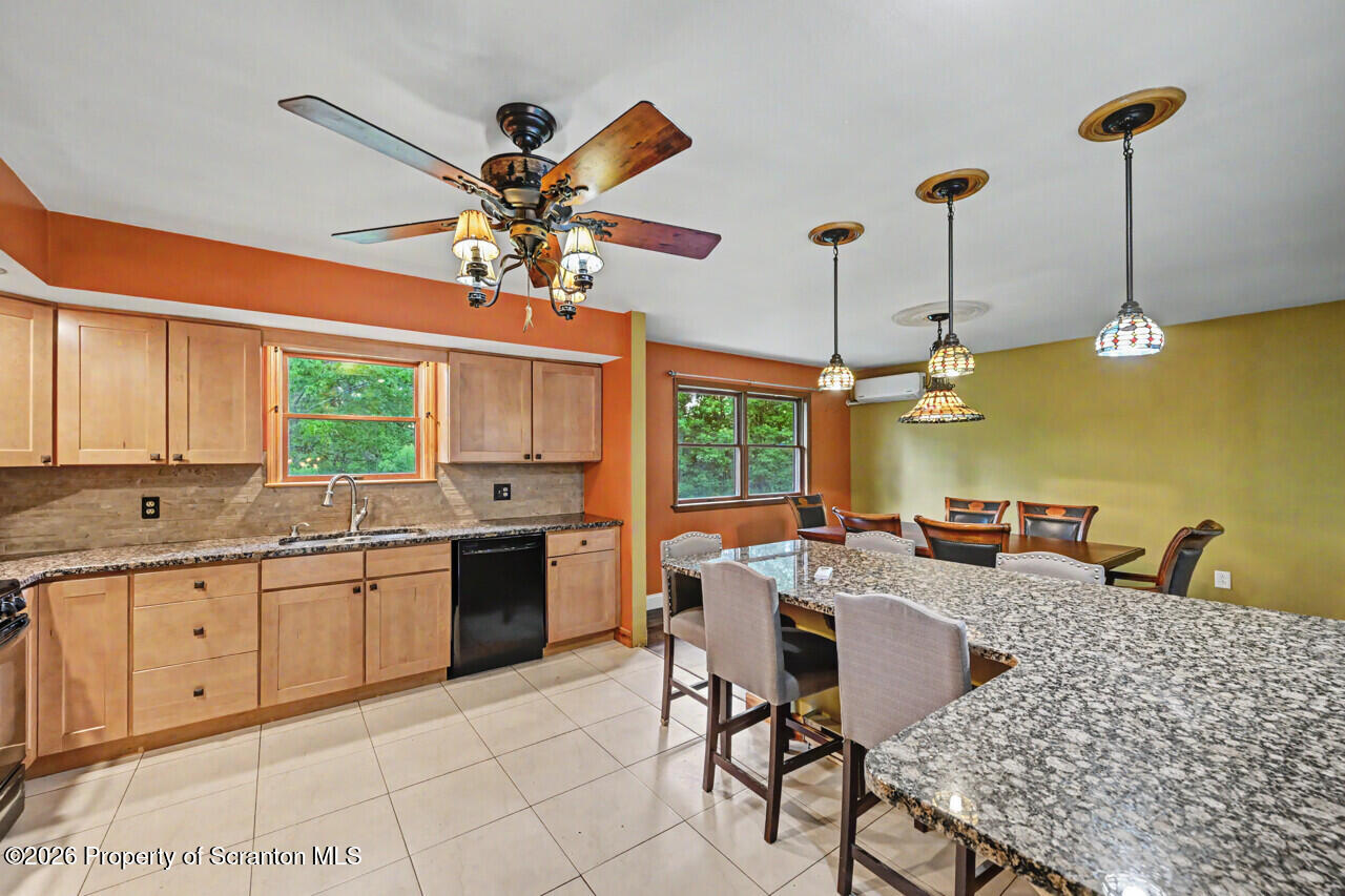 211 Buckingham Street Moscow, PA 18444 - Photo 29 of 83 a open kitchen with stainless steel appliances granite countertop a sink a stove and a refrigerator