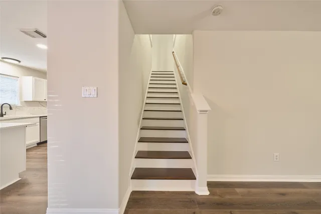 a view of entryway and hall with wooden floor