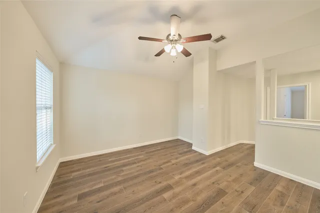 a view of a room with wooden floor closet and windows