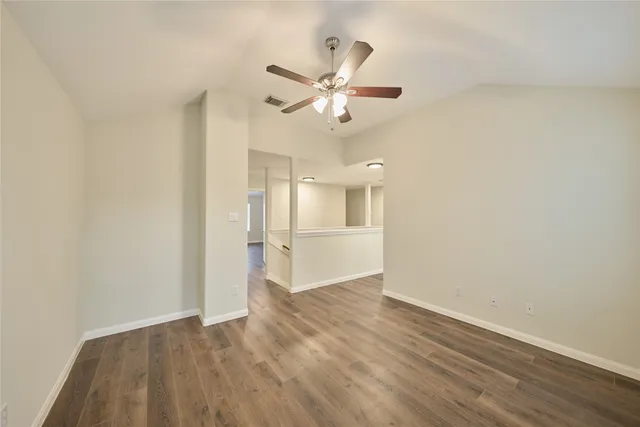 a view of an empty room and wooden floor