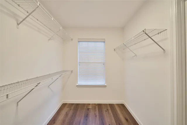 a view of a room with racks on the wall and a window