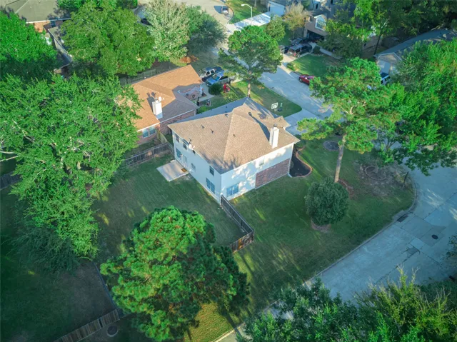 an aerial view of a house with a yard
