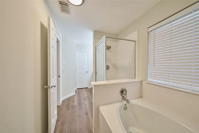a bathroom with a tub and a sink