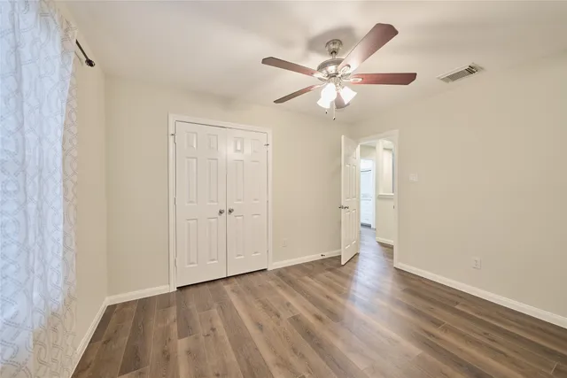 a view of an empty room and wooden floor