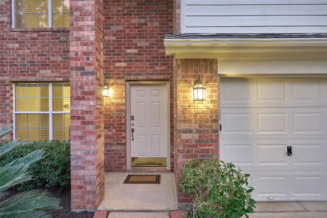 a view of front door of house with potted plants