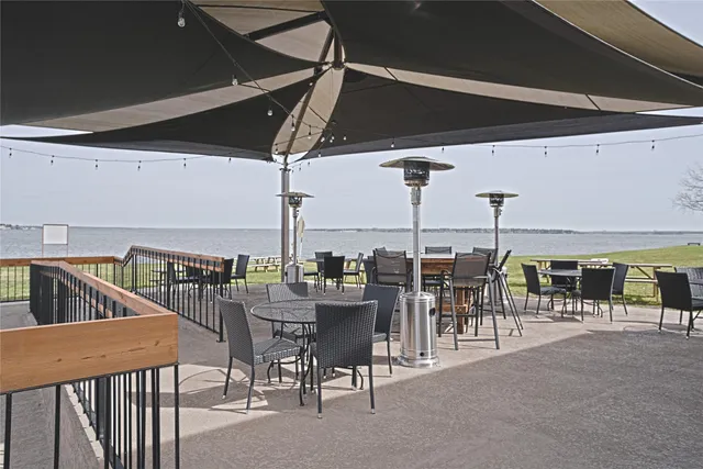 a view of a patio with a table and chairs