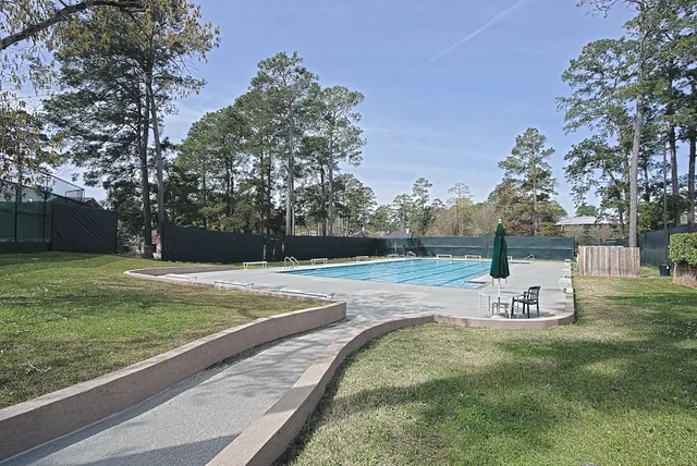 a view of a swimming pool with outdoor seating