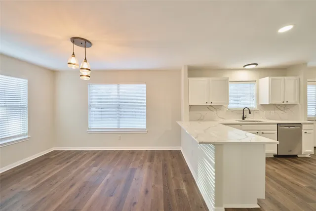 a kitchen with a sink stove and cabinets