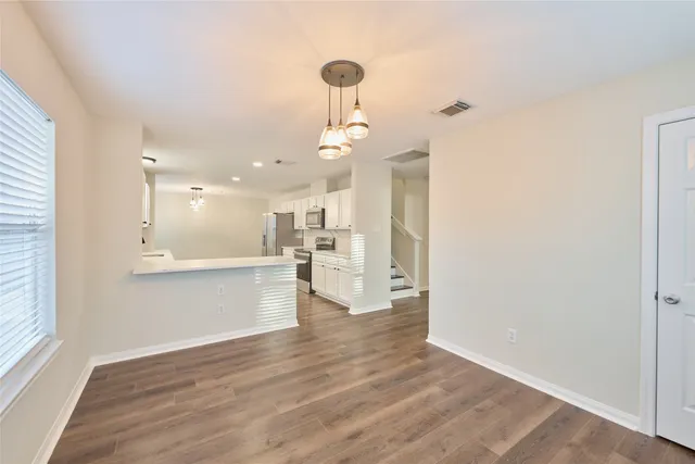 a view of a kitchen with wooden floor