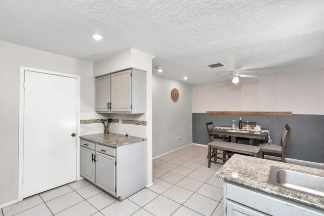a kitchen with a sink cabinets and window