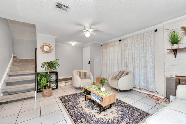 a living room with furniture and a potted plant