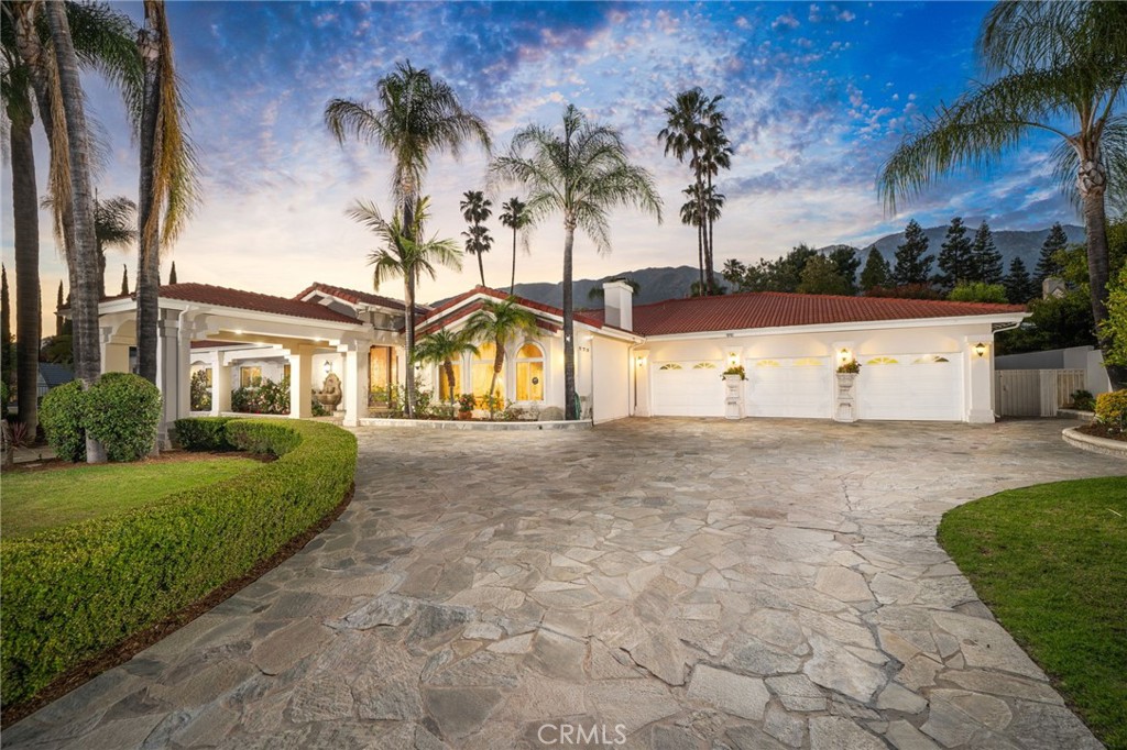 275 East 24th Street Upland, CA 91784 - Photo 1 of 74 a view of a white house with a yard and potted plants