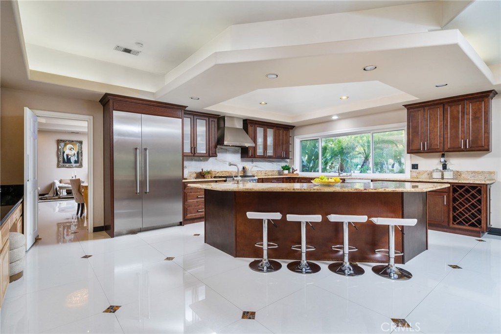 275 East 24th Street Upland, CA 91784 - Photo 15 of 74 a kitchen with a sink refrigerator and cabinets