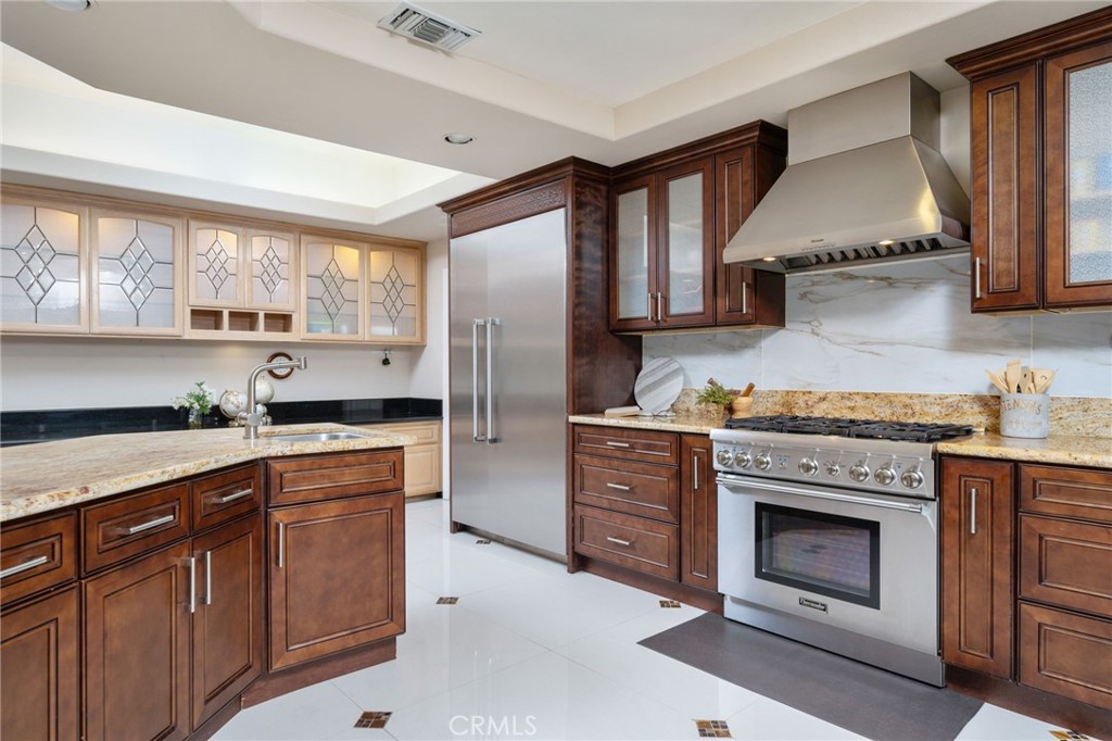 275 East 24th Street Upland, CA 91784 - Photo 17 of 74 a kitchen with stainless steel appliances granite countertop a stove a sink and a refrigerator