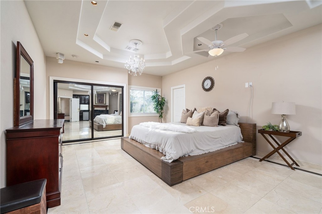 275 East 24th Street Upland, CA 91784 - Photo 22 of 74 a spacious bedroom with a bed and ceiling fan