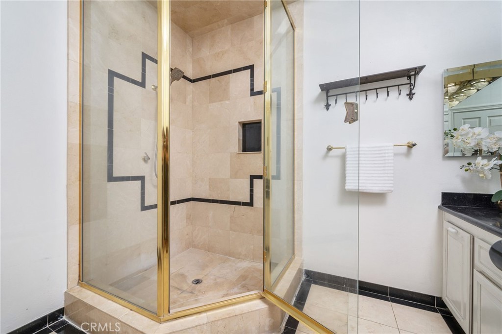 275 East 24th Street Upland, CA 91784 - Photo 30 of 74 a bathroom with a shower and a glass door