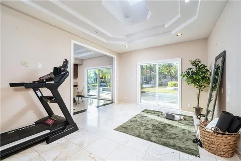 a view of a swimming pool with a table and chairs under an umbrella