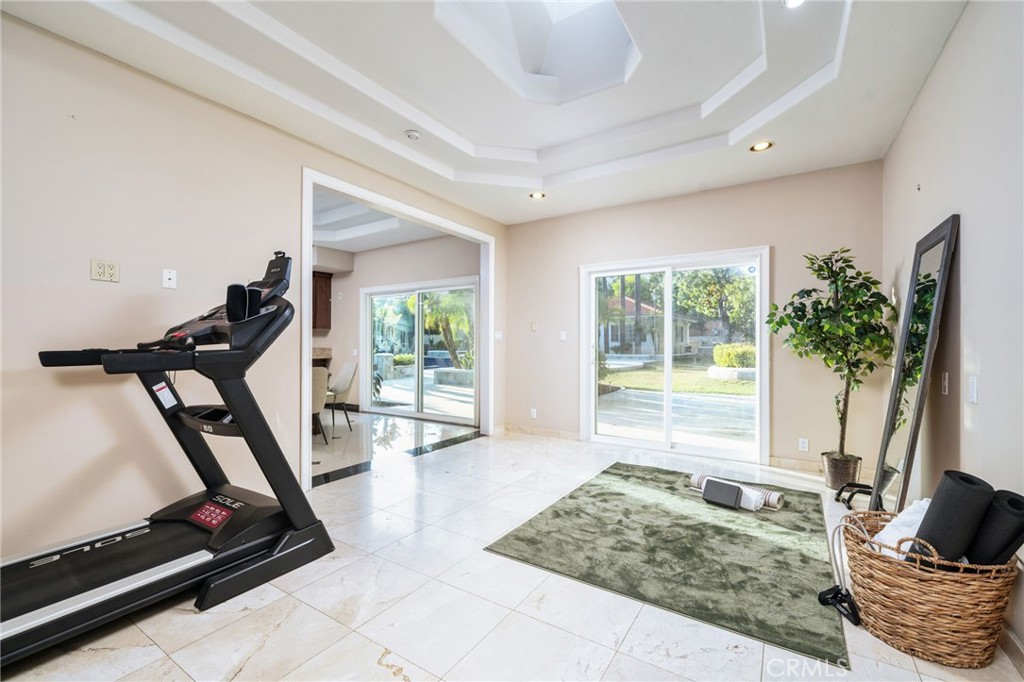 275 East 24th Street Upland, CA 91784 - Photo 34 of 74 a living room with furniture gym equipment and a large window