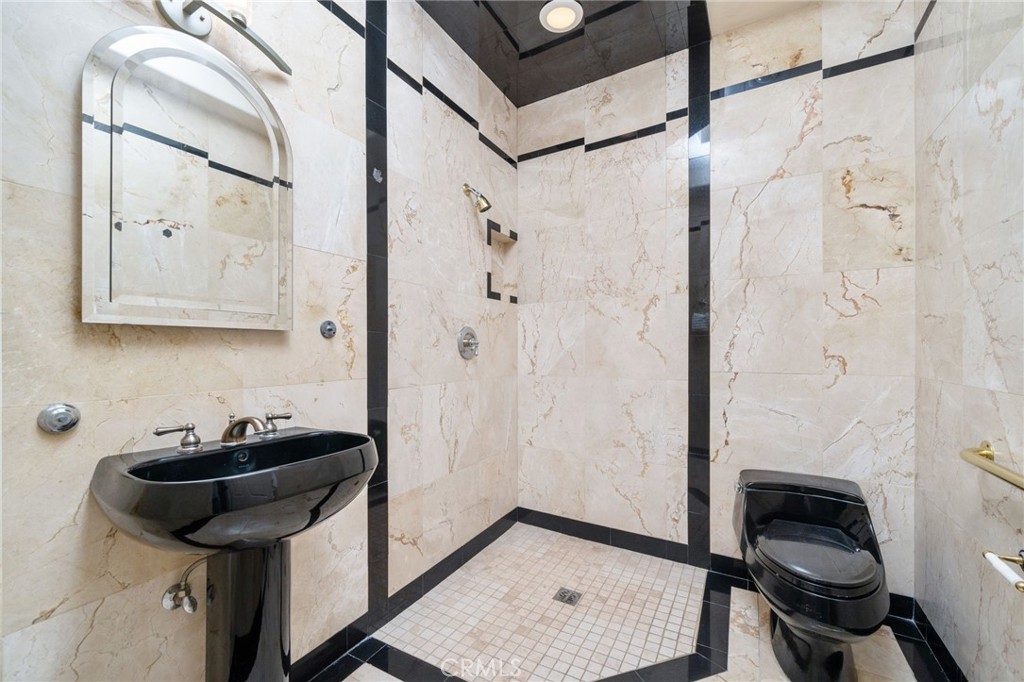 275 East 24th Street Upland, CA 91784 - Photo 35 of 74 a bathroom with a granite countertop sink a toilet and shower