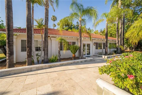 a view of house with outdoor space and swimming pool