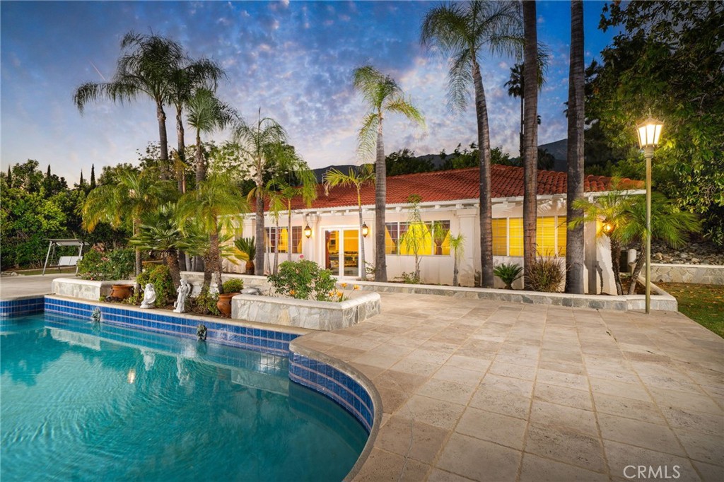 275 East 24th Street Upland, CA 91784 - Photo 38 of 74 a swimming pool with outdoor seating and yard