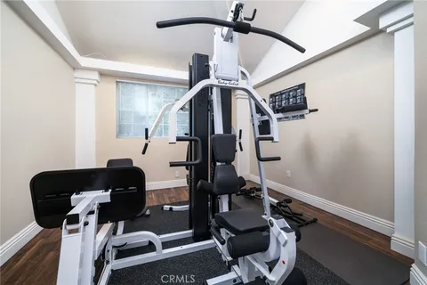 a front view of a house with a yard and potted plants