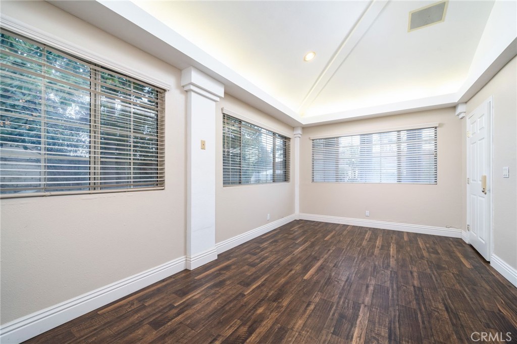 275 East 24th Street Upland, CA 91784 - Photo 44 of 74 a view of an empty room with wooden floor and a window