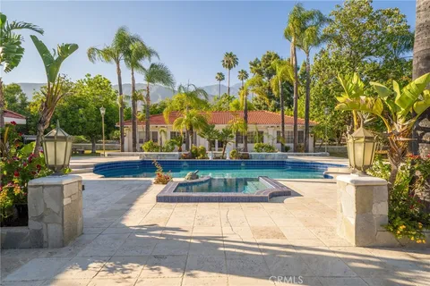 an aerial view of residential house with outdoor space and swimming pool