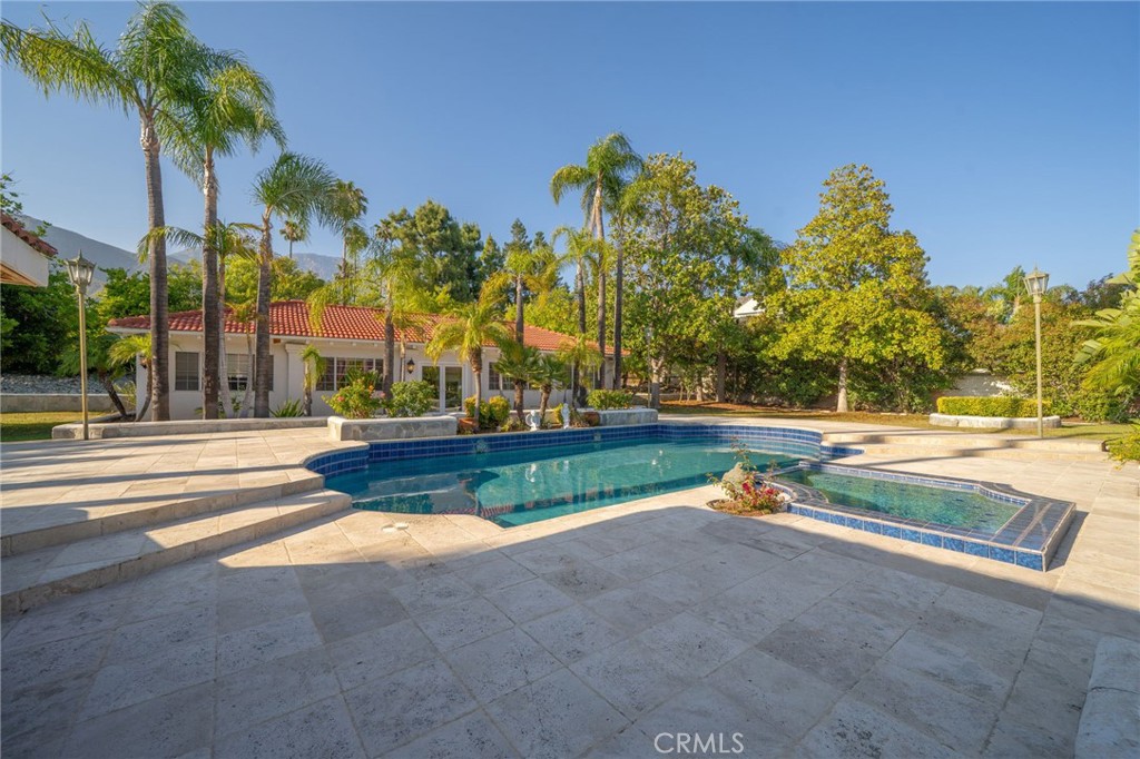 275 East 24th Street Upland, CA 91784 - Photo 46 of 74 a view of yard with swimming pool and tall trees