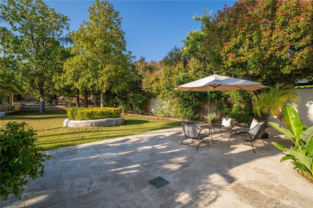 275 East 24th Street Upland, CA 91784 - Photo 49 of 74 a view of a swimming pool with a table and chairs under an umbrella
