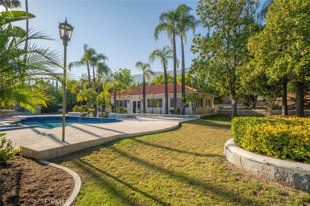 275 East 24th Street Upland, CA 91784 - Photo 52 of 74 a swimming pool with outdoor seating and yard
