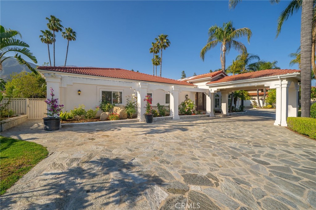 275 East 24th Street Upland, CA 91784 - Photo 57 of 74 a front view of a house with a yard and potted plants