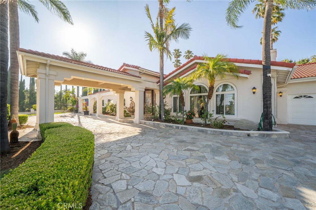275 East 24th Street Upland, CA 91784 - Photo 58 of 74 a view of a white house with a large windows and flower plants
