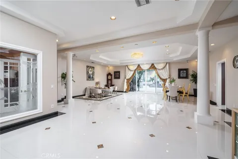 a dining room with furniture and a large window