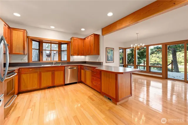 a large kitchen with stainless steel appliances granite countertop a large counter top and a stove
