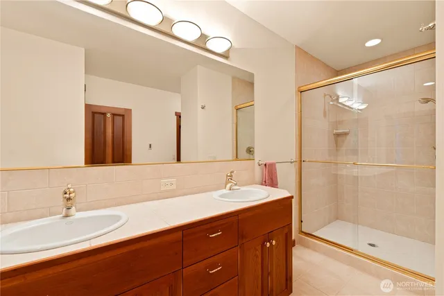a bathroom with a sink double vanity and shower