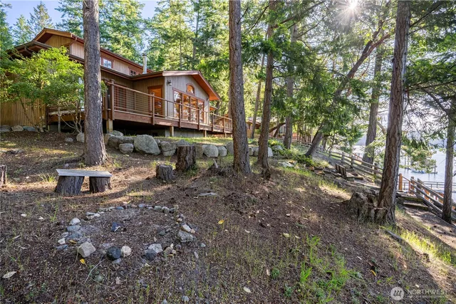 a view of a house with a yard tree and sitting area