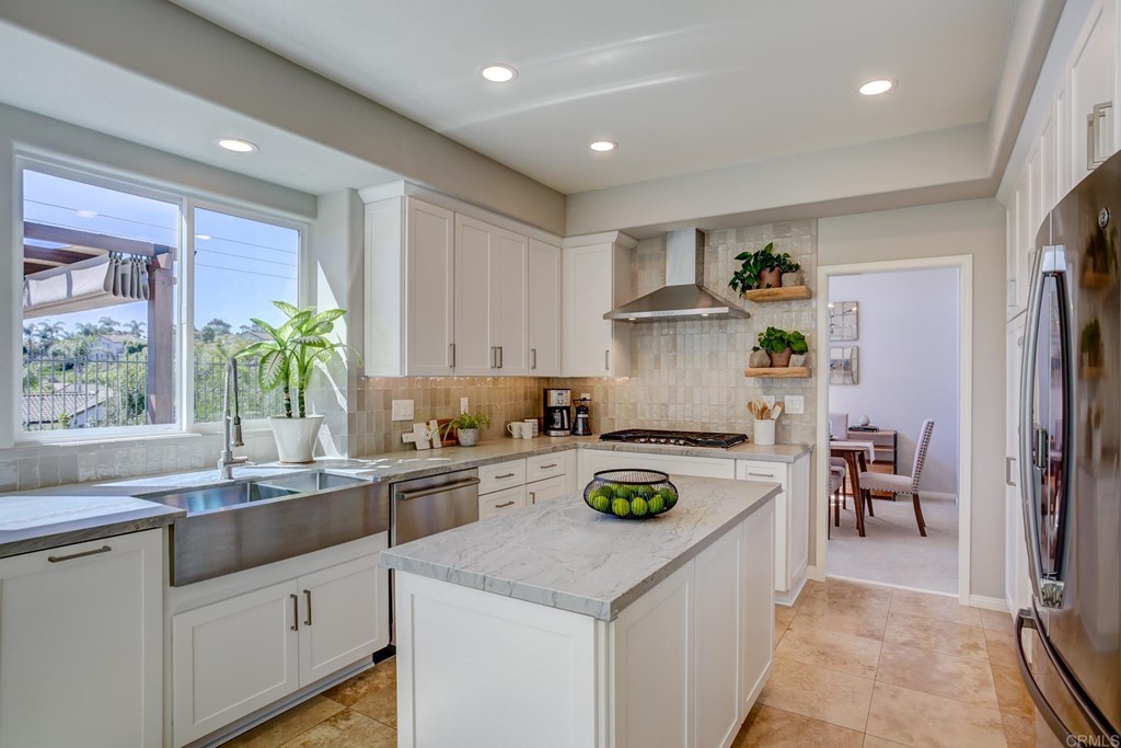 1732 Blackbird Circle Carlsbad, CA 92011 - Photo 11 of 39 a kitchen with a sink a stove and refrigerator