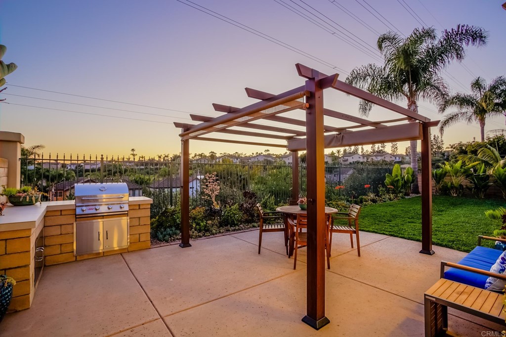 1732 Blackbird Circle Carlsbad, CA 92011 - Photo 18 of 39 a view of a patio with a table chairs and a backyard