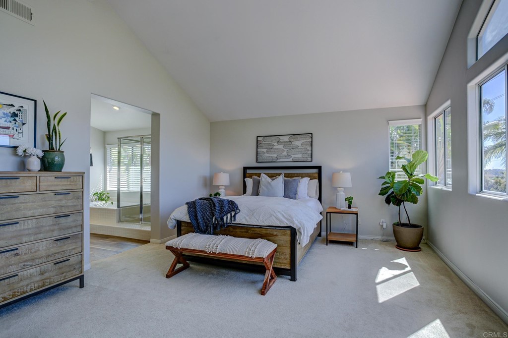 1732 Blackbird Circle Carlsbad, CA 92011 - Photo 27 of 39 a bedroom with a bed and a potted plant