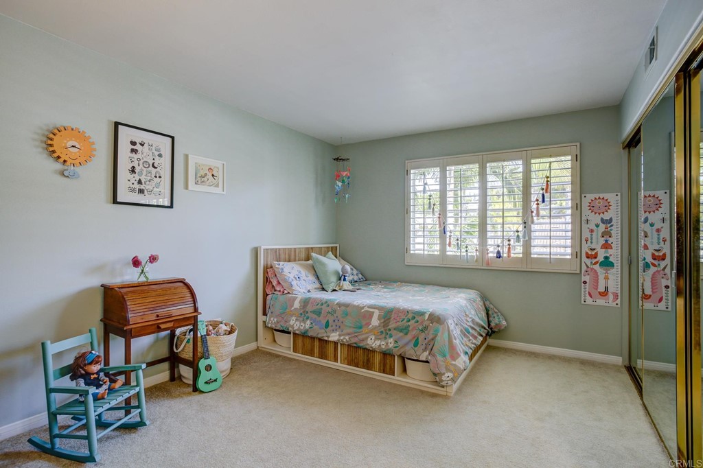 1732 Blackbird Circle Carlsbad, CA 92011 - Photo 30 of 39 a bedroom with a bed and a window