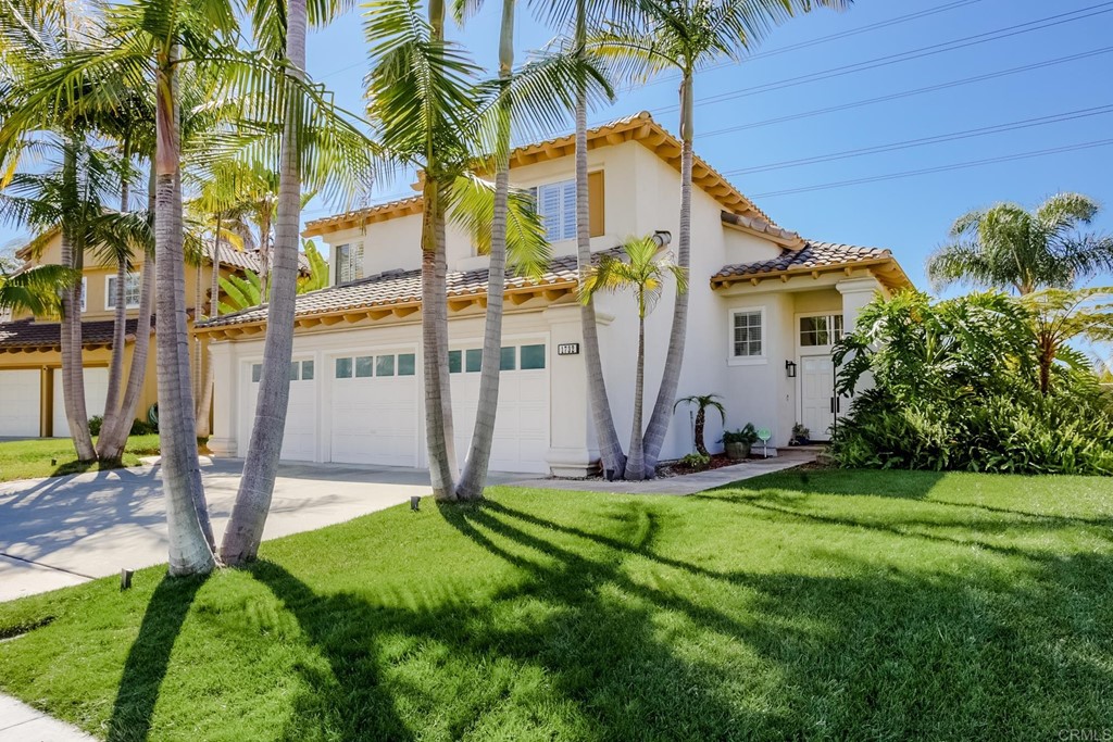 1732 Blackbird Circle Carlsbad, CA 92011 - Photo 3 of 39 a backyard of a house with potted plants and large tree