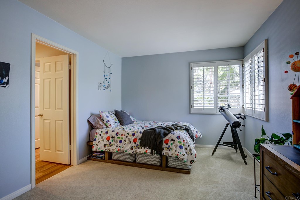 1732 Blackbird Circle Carlsbad, CA 92011 - Photo 32 of 39 a bedroom with a bed and a window