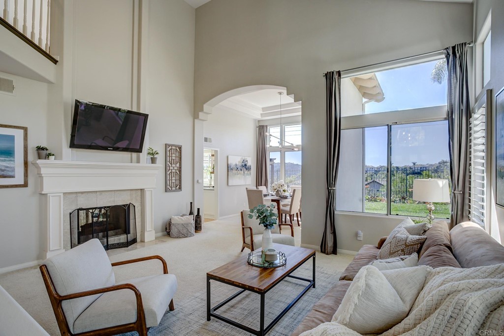 1732 Blackbird Circle Carlsbad, CA 92011 - Photo 5 of 39 a living room with furniture a fireplace and a flat screen tv