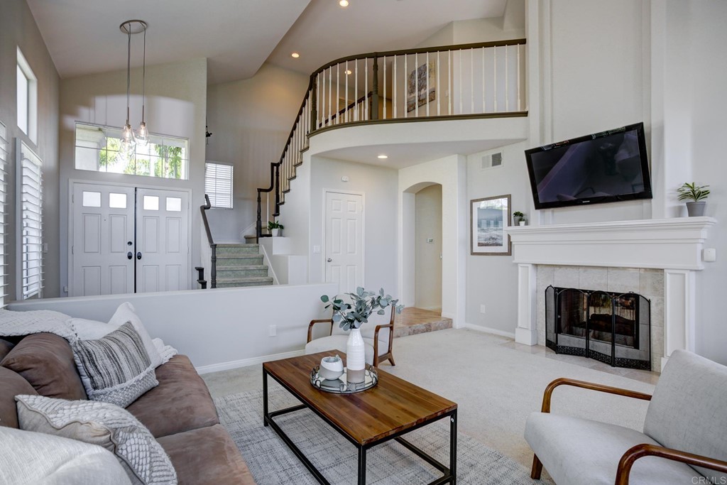1732 Blackbird Circle Carlsbad, CA 92011 - Photo 7 of 39 a living room with furniture a fireplace and a flat screen tv