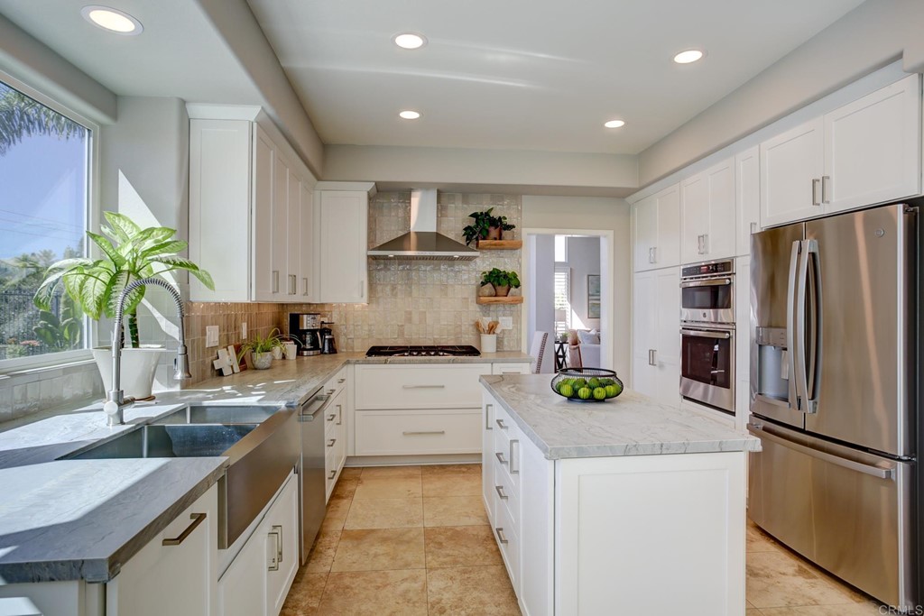 1732 Blackbird Circle Carlsbad, CA 92011 - Photo 10 of 39 a kitchen with a refrigerator a sink and a stove
